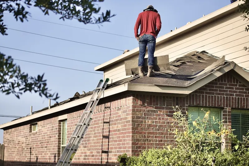 Professional roofer working on a residential roof in Montyville